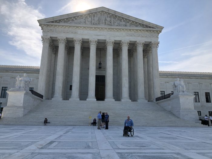 image of the sun rising over United States Supreme Court building 